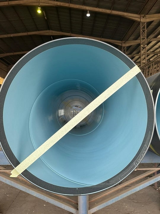 Internal tank coating system applied to large-diameter pipe sections