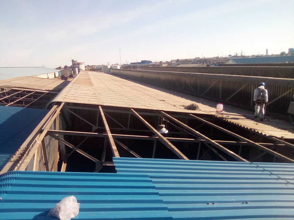 Stripped roof sections ready for new sheeting installation at port facility