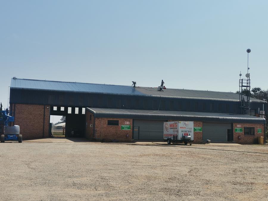 Makhaya Corrosion Control workshop and equipment store with crews on roof