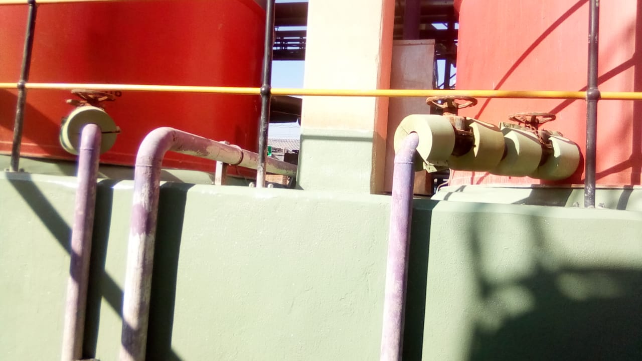 Coated bund wall around acid storage tanks with valve detail