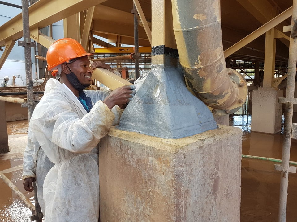 Applicator finishing protective coating on plant column baseplate