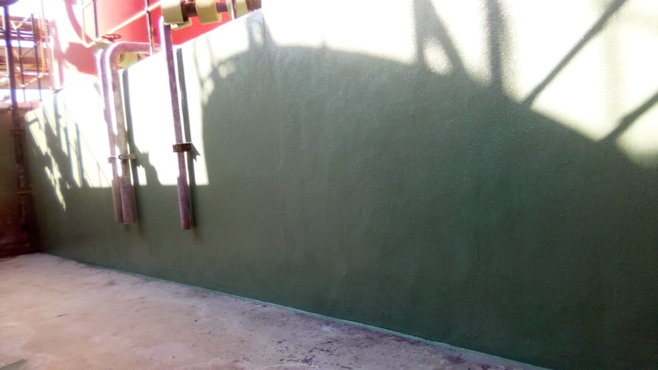Smooth chemical-resistant coating on bund interior wall