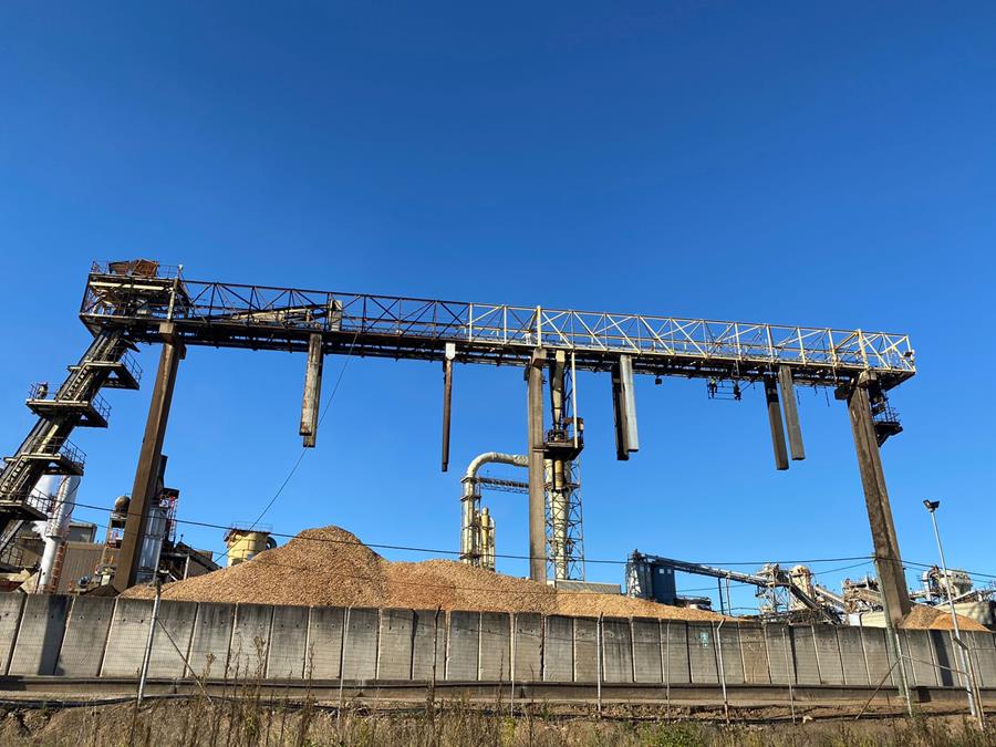 Wide view of materials handling gantry and processing plant under blue sky