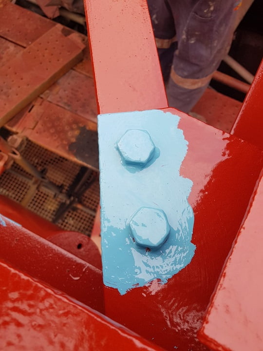 Stripe coat applied to bolted connection prior to top coat