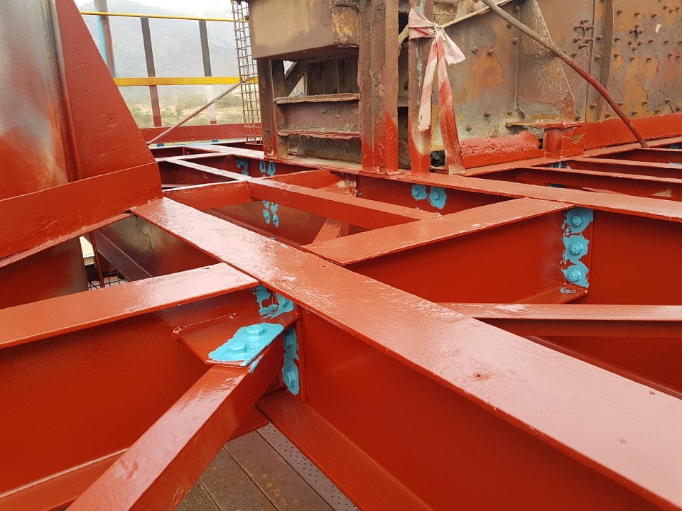 Bolted structural framework with stripe coats on connections