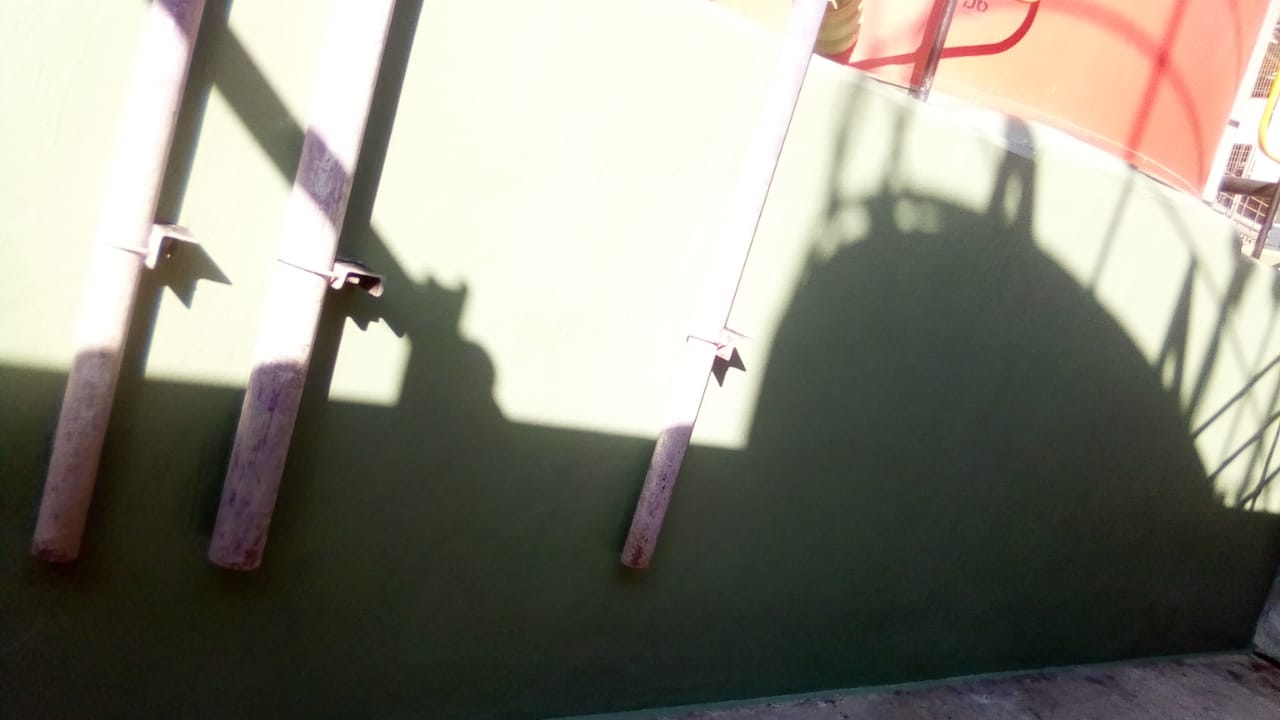 Coated bund wall with through-wall pipe penetrations