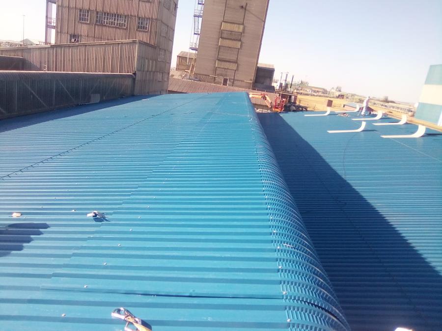 Refurbished blue roof sheeting on industrial facility