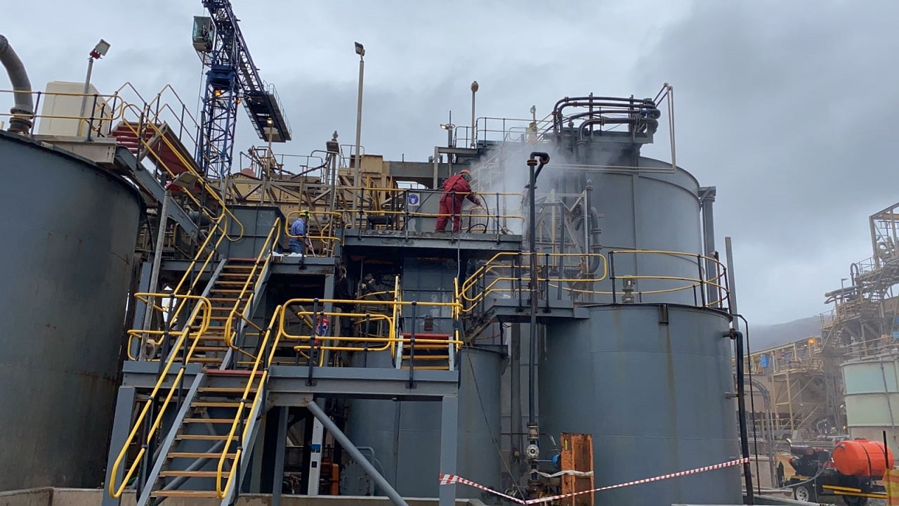 Spray application of protective coating to plant tankage at height