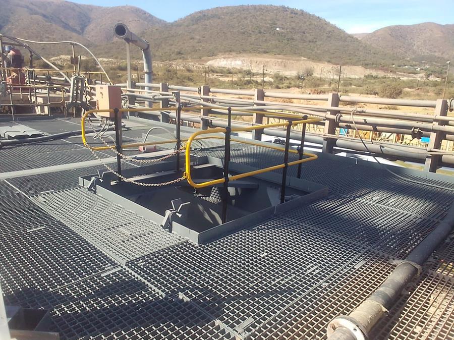 Coated platform grating and access hatch at minerals plant