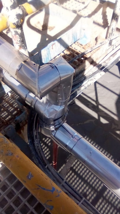 Metal cladding on insulated pipework elbow and tee assembly