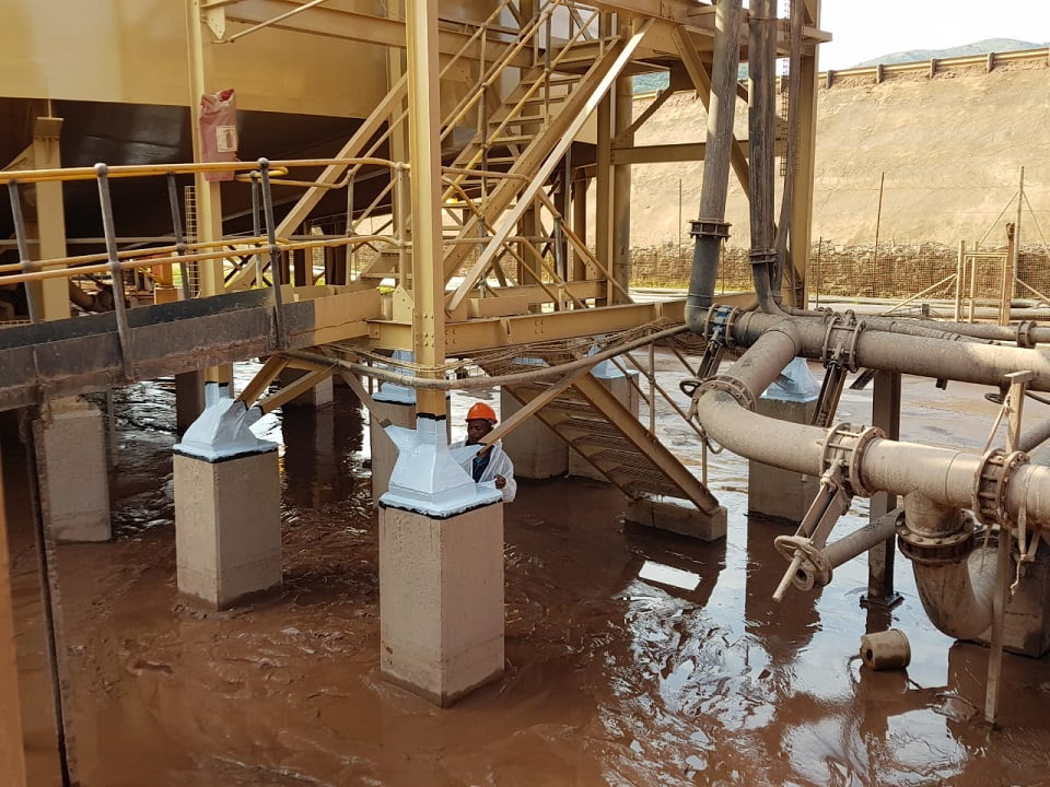 Multiple coated column baseplates protected from process spillage