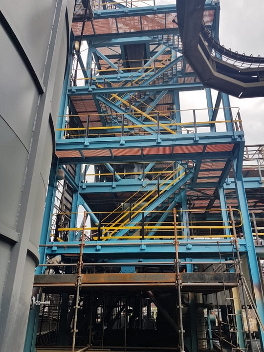 Refurbished plant structure repainted in vibrant blue protective coating