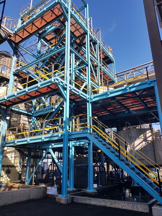 Multi-level plant structure freshly coated in blue with yellow safety highlights