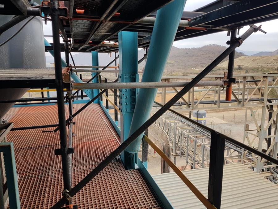 Freshly coated teal structural columns and platform at processing plant