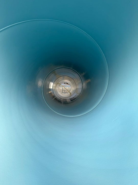 Internal view of pipe section with smooth pale-blue protective lining