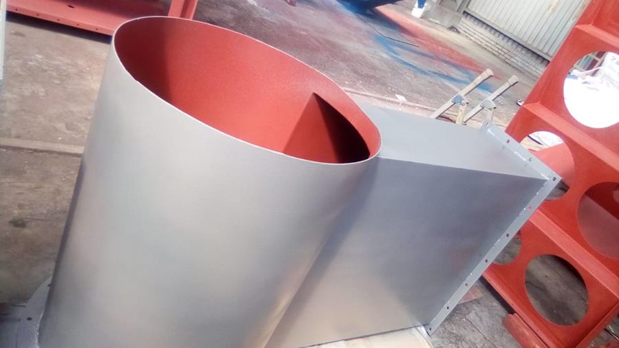 Freshly coated ducting component with grey exterior and red internal lining