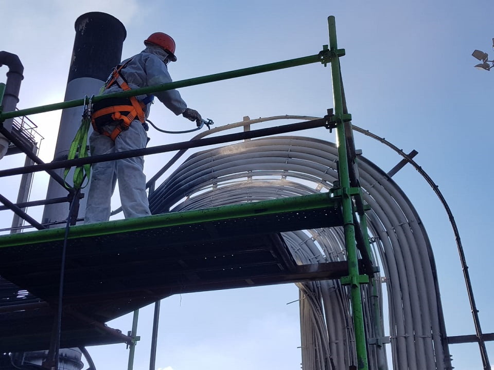 Working at height applying intumescent fireproofing to elevated pipework
