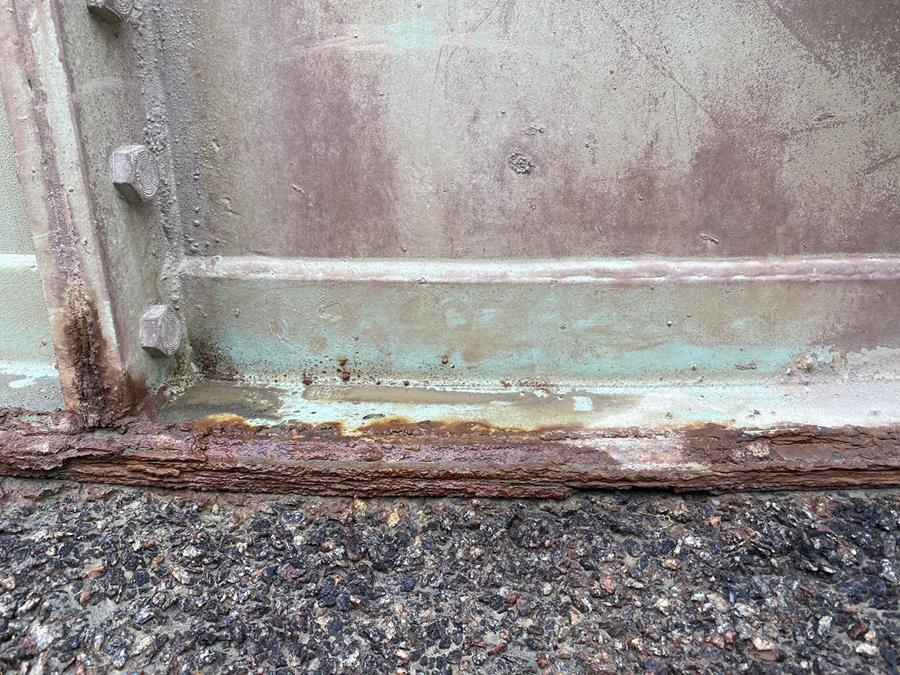 Severely corroded structural steel base prior to refurbishment