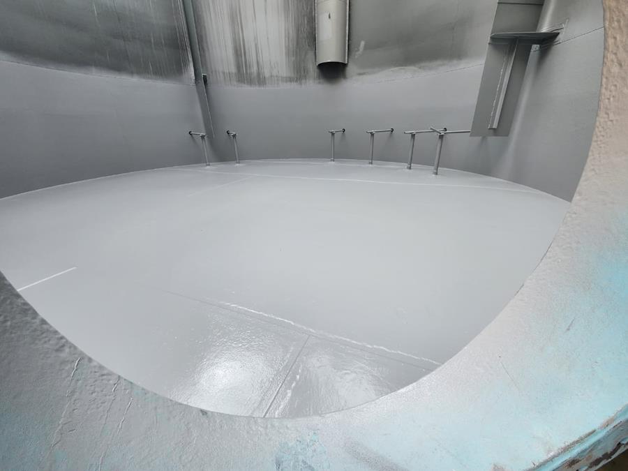 Internal view of newly lined storage tank with smooth grey coating