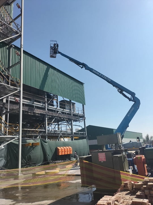 Telescopic boom lift providing access to elevated plant structure