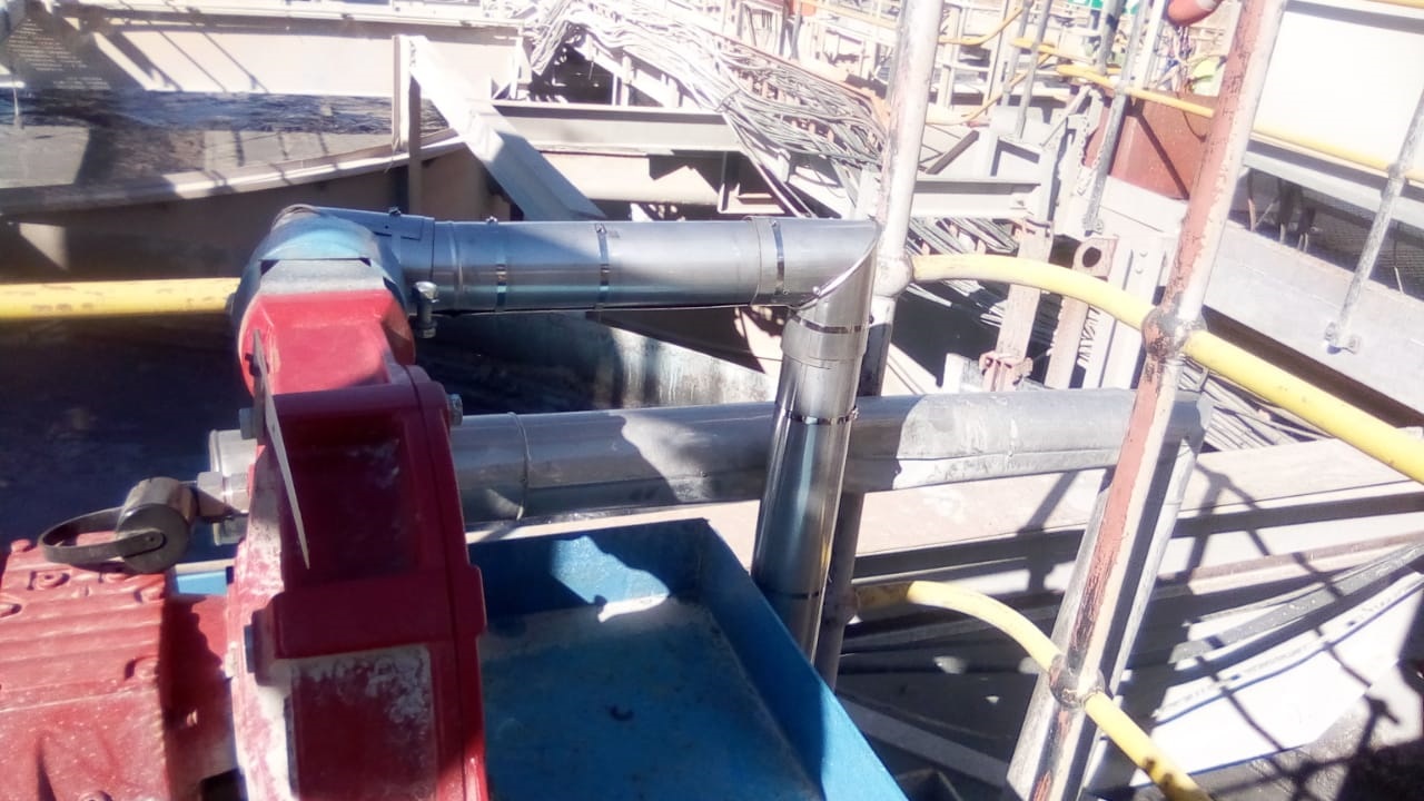 Cladded insulation on pipework around plant pump and gearbox