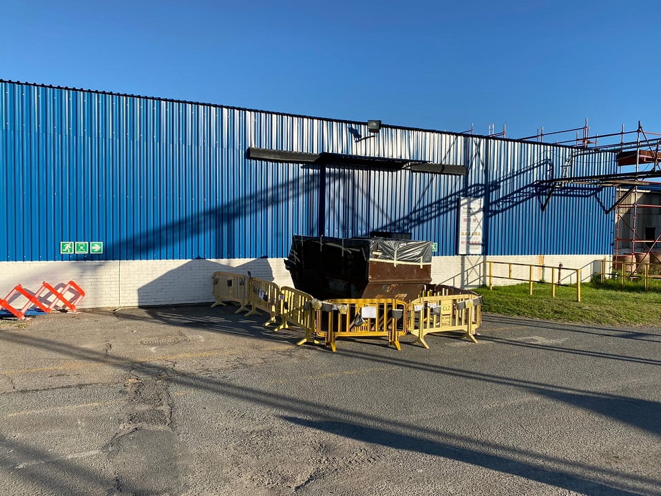 Refurbished blue side sheeting on workshop with safety barricades