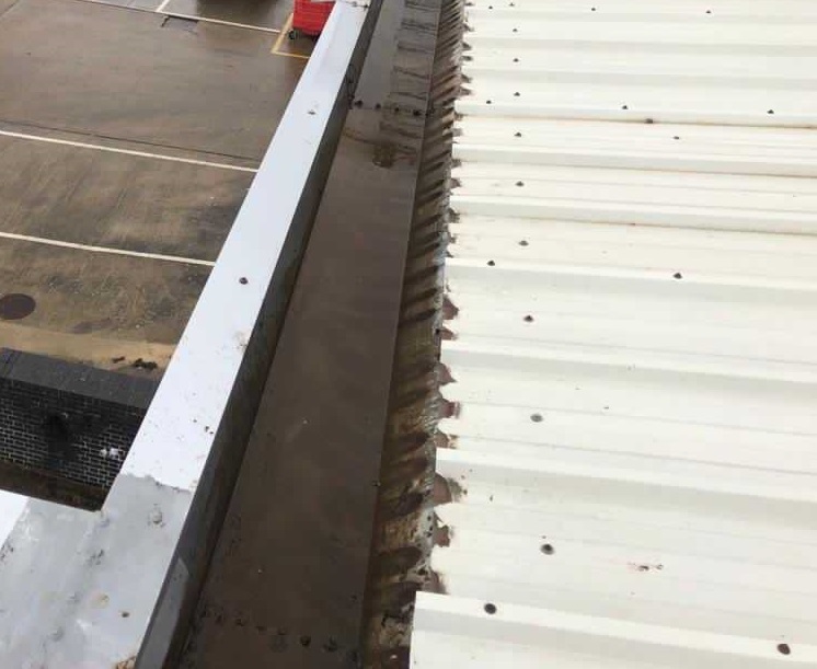 Commercial parapet gutter after clearing and inspection
