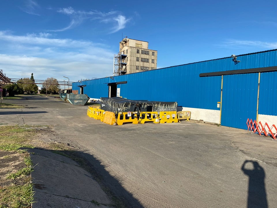 Long industrial workshop wall finished with bright blue side sheeting