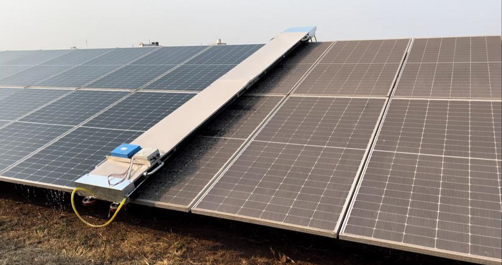 Automated cleaning robot traversing a solar panel array