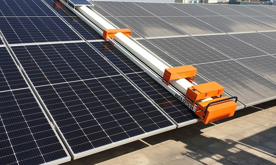 Automated scrubbing robot cleaning rooftop solar panels