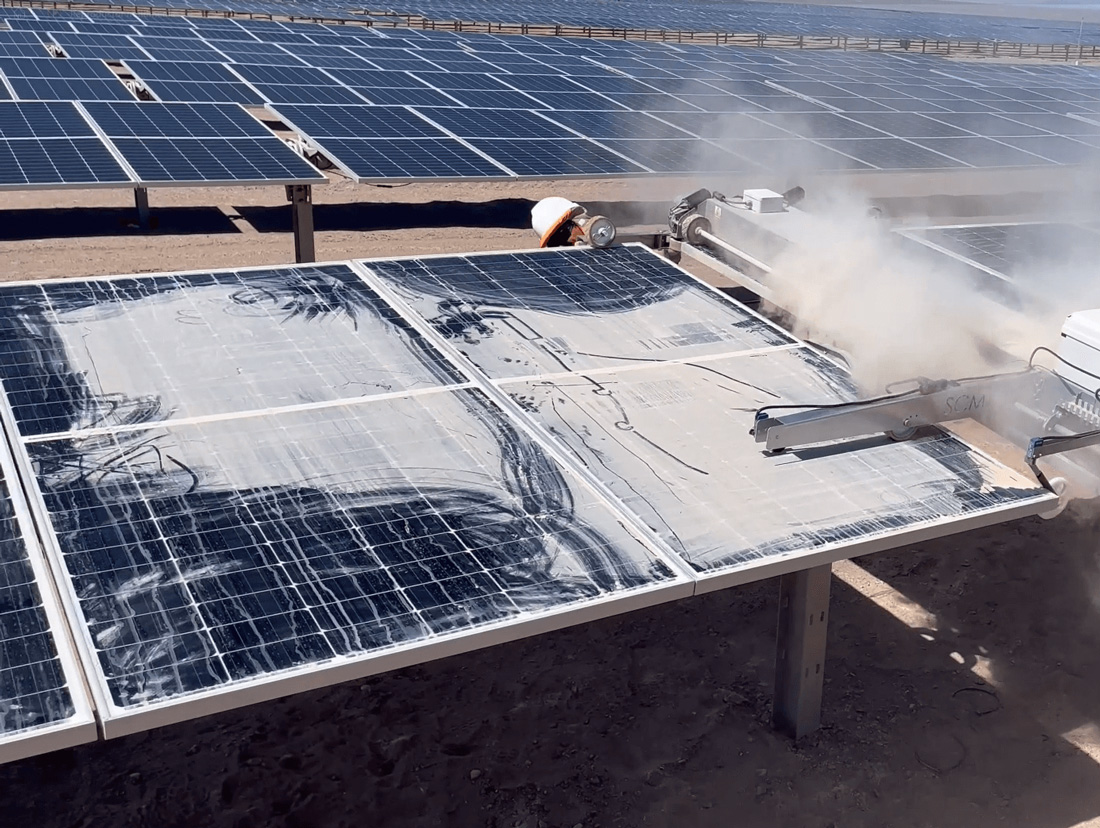 Industrial solar panel cleaning robot spraying panels in the field