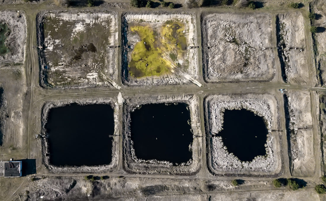Aerial view of industrial sludge ponds suited to robotic cleaning